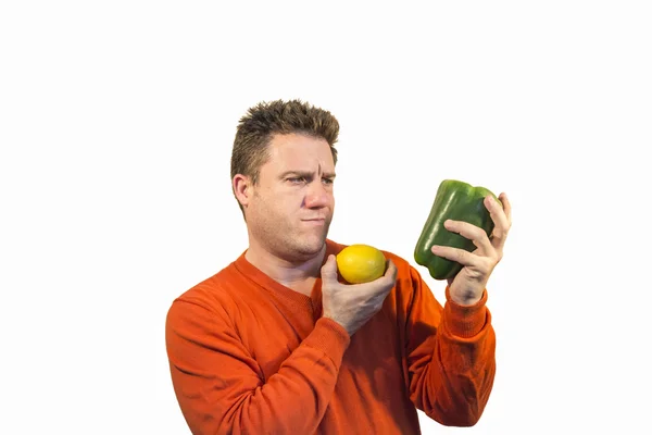 Thoughtful man holding fruits and vegetables — Stock Photo, Image