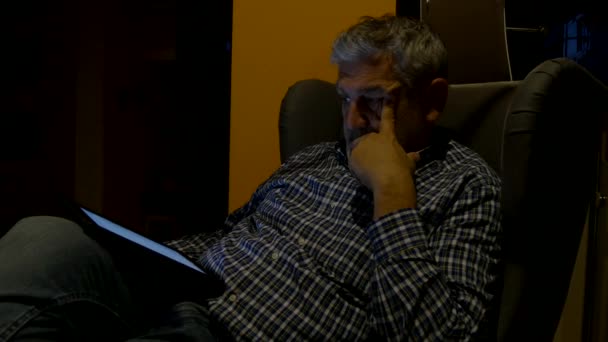 Man sitting looking tablet at night. 4K — Stock Video