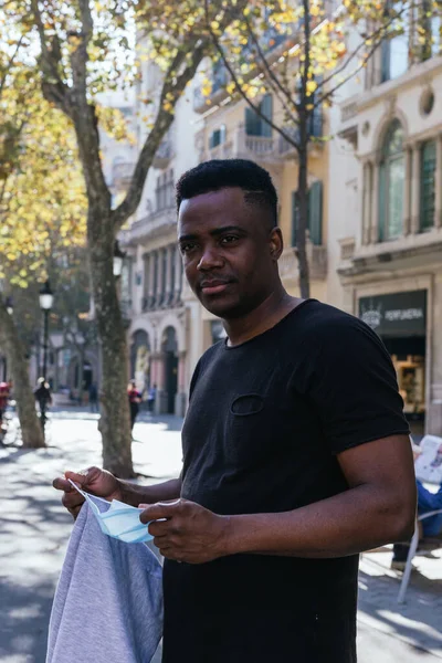 Afrika kökenli Amerikalı kameraya bakıyor. Tam 19 numaralı maskesini takmadan önce.