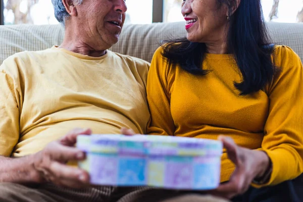 Tanınmayan orta yaşlı bir çift hediye veriyor.