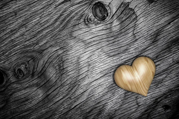 Wooden heart isolated on a wooden floor — Stock Photo, Image