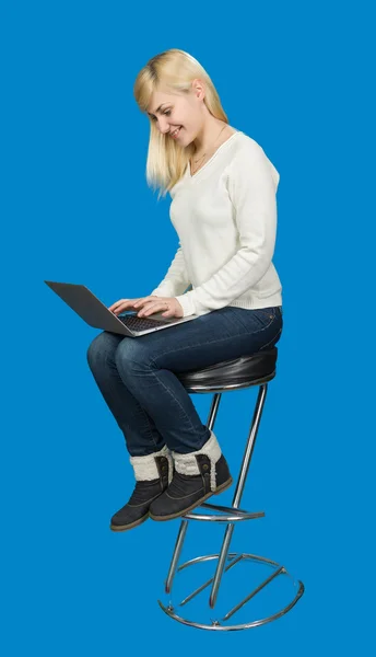 Business woman sitting a high chair and works on the laptop — Stock Photo, Image