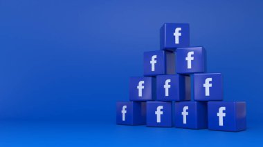 Mavi arkaplan üzerine bir yığın facebook kübik logosunun 3B görüntülenmesi