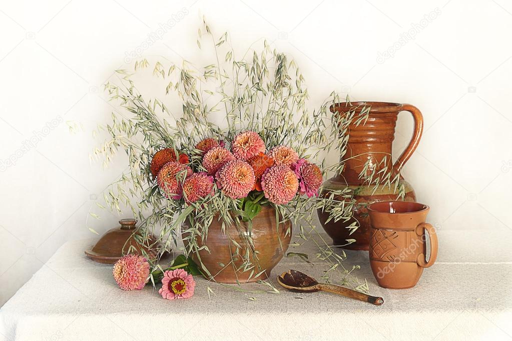 Still life with pink flowers and clay pots