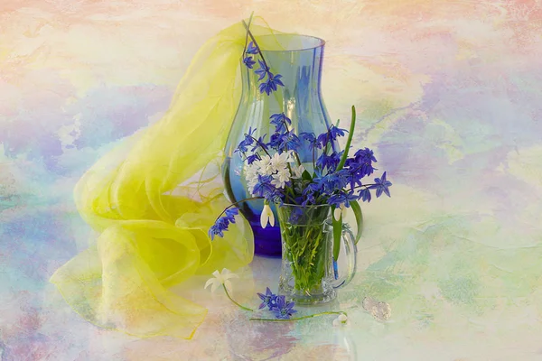 Blue pitcher with yellow transparent fabric and glass vase with snowdrops . — Stock Photo, Image