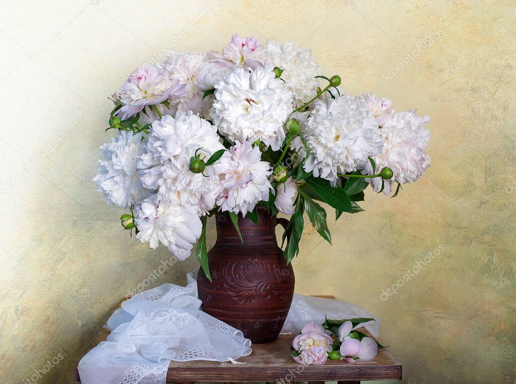 Still life with white peonies in a vase .