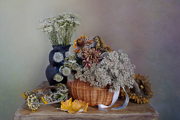 Dry flowers and herbs, leaves. Still life of dried flowers and herbs in a wicker baske