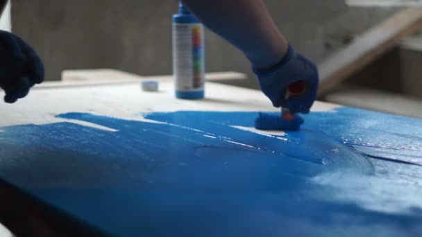 Painting workshop. Carpenter paint wooden surface with blue — Stock Video