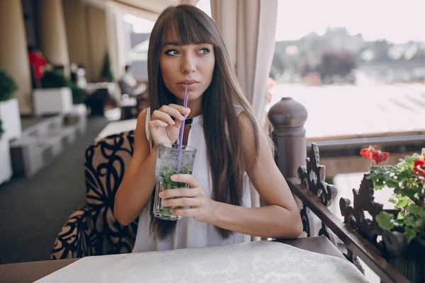 Girl drinks mojito — Stock Photo, Image