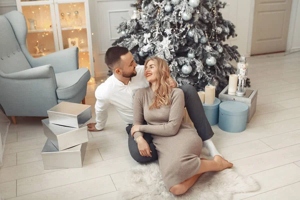 Couple élégant assis à la maison près de l'arbre de Noël — Photo
