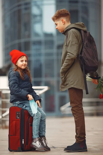 Un niño está de pie con un ramo de tulipanes y dando flores a una niña —  Fotos de Stock