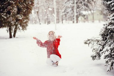 Kış parkında zarif ve genç bir kız.