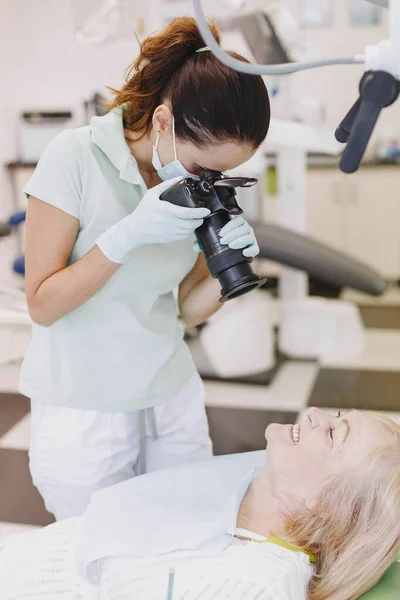 Dentista olhando seu velho paciente com ferramentas — Fotografia de Stock