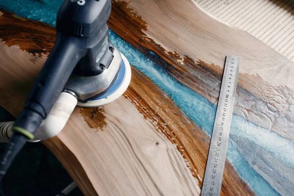 Man is processing with wood by polishing machine — Stock Image Man is processing with wood by polishing machine Royalty Free Stock Photos