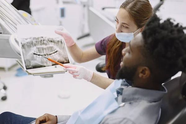 Paciente africano en odontología sentado en silla dental — Foto de Stock