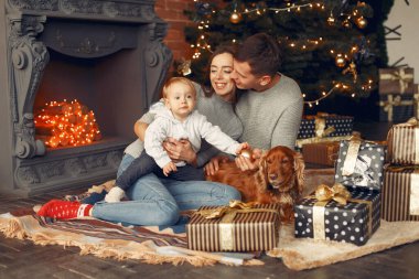 Noel ağacının yanında sevimli köpekli bir aile.