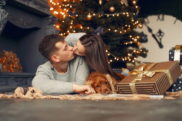 Elegante pareja en casa cerca del árbol de Navidad —  Fotos de Stock