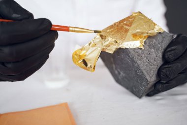 Beyaz gömlekli adam çimentoyla çalışıyor.