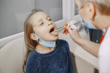 Muayene için doktordaki küçük mutlu kız.