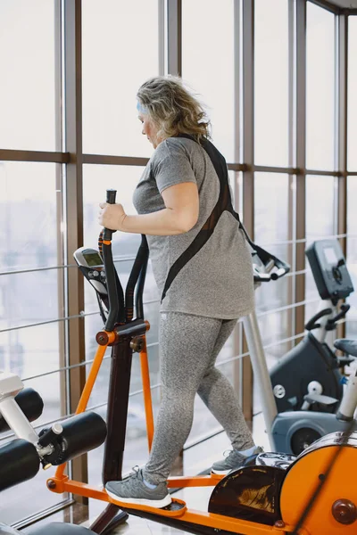 Mulher gorda adulta fazendo ginástica no ginásio — Fotografia de Stock