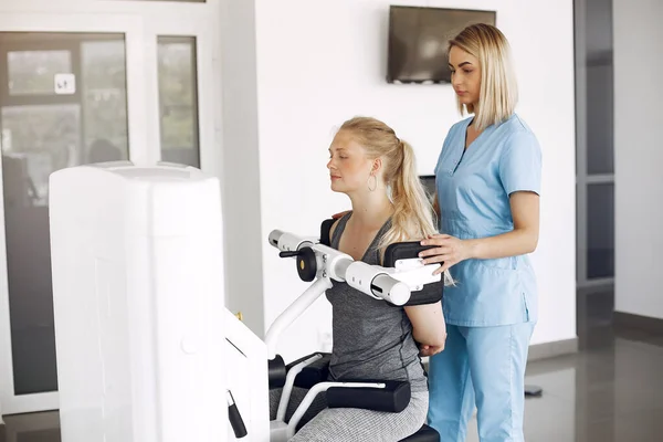 Physiotherapeutin macht mit ausgebildeter Therapeutin körperliche Übungen — Stockfoto