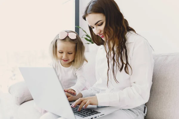 Woman with daughter using laptop computer