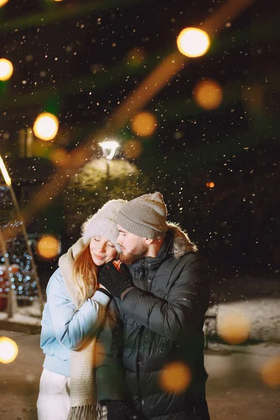 Young couple outdoor in night street at christmas time — Stock Photo, Image