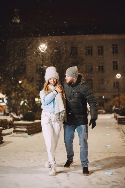 Young couple outdoor in night street at christmas time — Stock Photo, Image