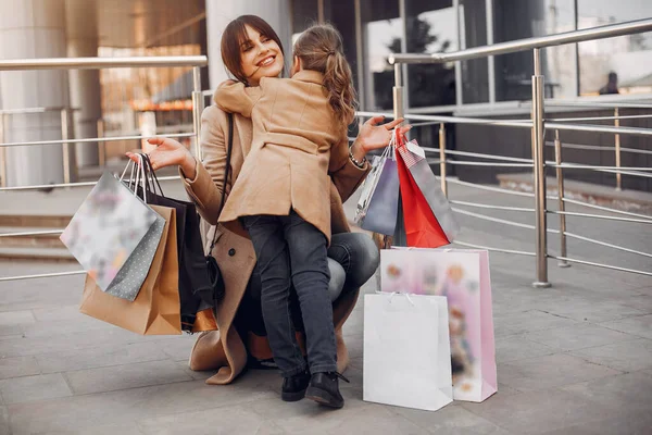 Mother and daughter with shopping bag in a city