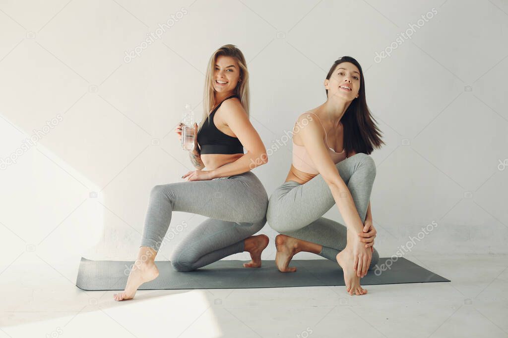 A beautiful girls is engaged in a yoga studio