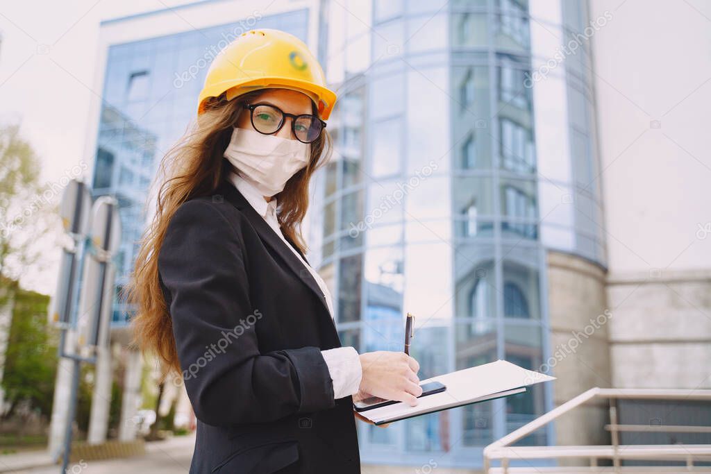 Female architect with construction site on the background