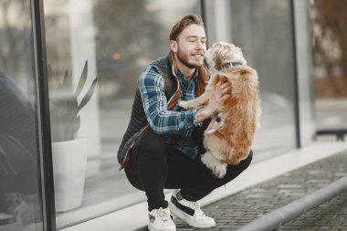 Man with a dog in a city