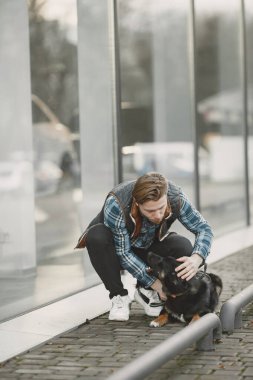 Man with a dog in a city