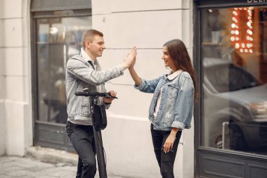 Beautiful couple spend time in a autumn city