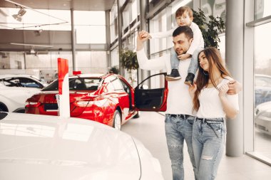 Family with little son in a car salon