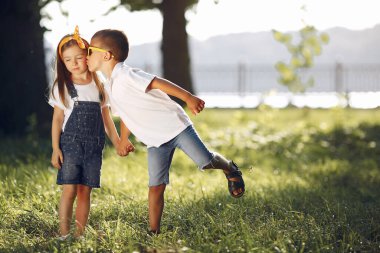 Cute little girl playing in a park with her friend