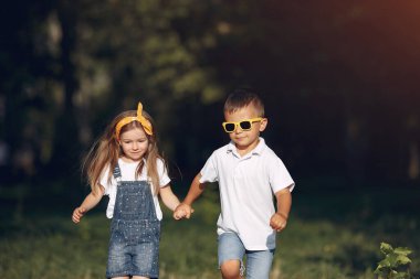 Cute little girl playing in a park with her friend