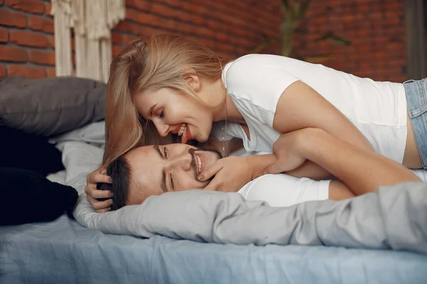 Paar zitten op een bed in een kamer — Stockfoto