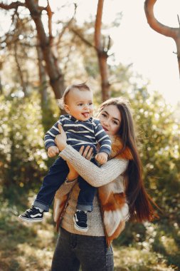 Anne ve oğlu yaz parkında oynuyorlar.