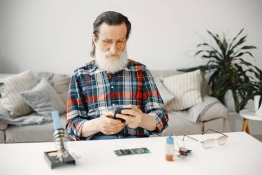 Tamirden sonra üst düzey teknisyen telefonu kontrol ediyor.