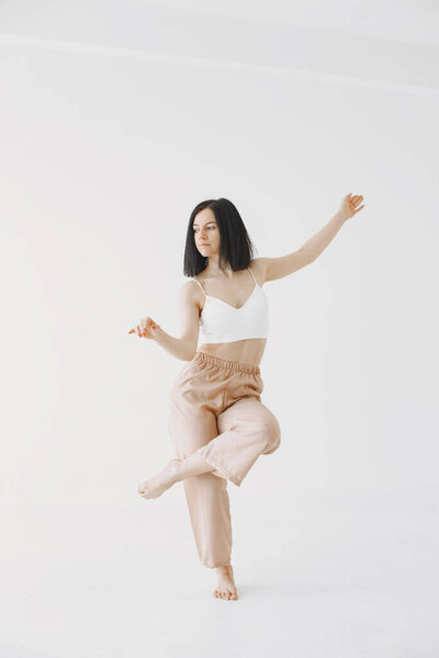 Beautiful young woman dancing in studio