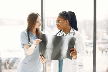 İki kadın doktor röntgene bakıyor.