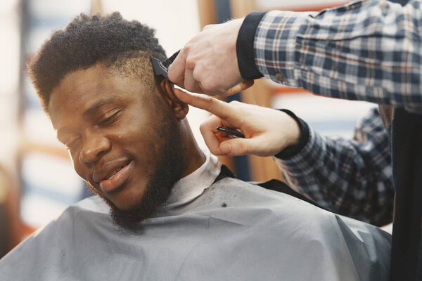 Young African-american man visiting barbershop