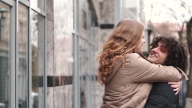 Tutkulu genç çift öpüşme ve etrafında dönen kucaklayan açık şehir