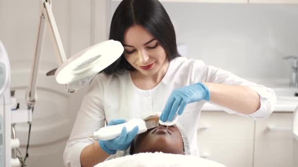 Esthéticienne fait la procédure pour nettoyer le visage avec du matériel — Video