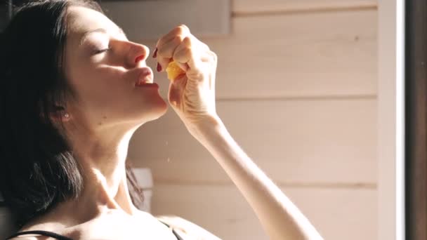 きれいな女性はオレンジからジュースを絞る — ストック動画
