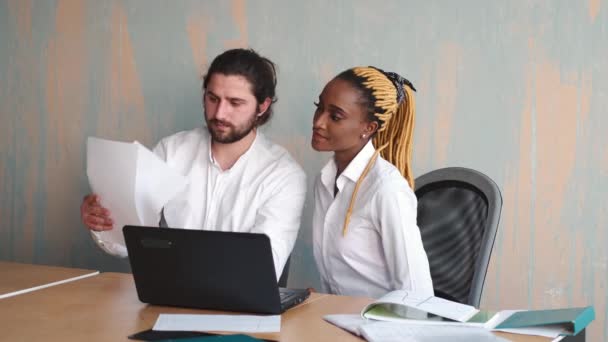 아름다운 아프리카 사업가와 코카서스 남자가 노트북을 가지고 일하는 모습 — 비디오