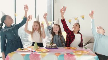 Bir grup çocuk dekore edilmiş evde doğum günü partisi veriyor.