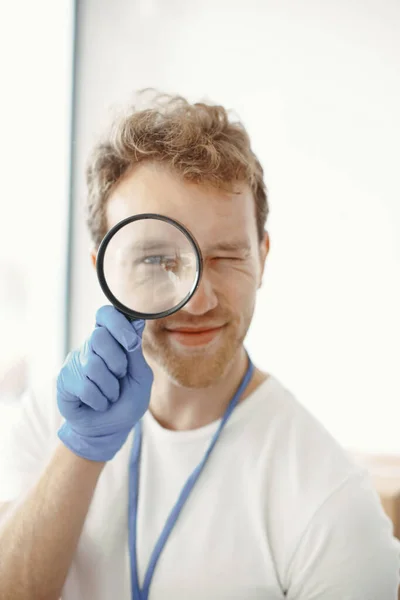 Man with a magnifying glass attached to his face