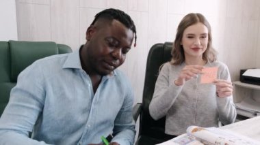 Afrikanm Amerikalı erkek ve kadın öğretmen özel derste İngilizce öğretiyor.